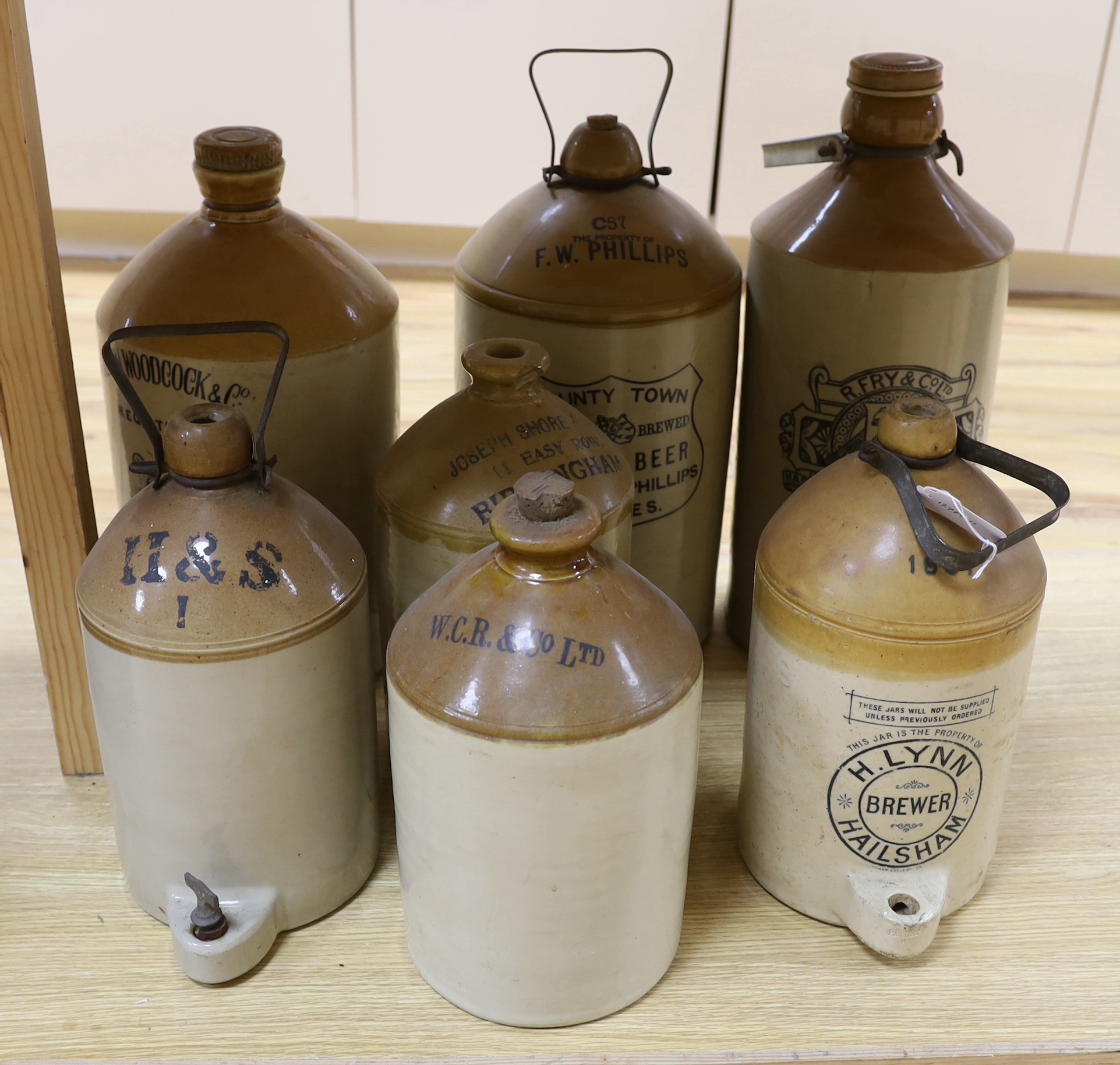 Seven various stoneware vessels including one Lewes brewer, largest 49cm high
